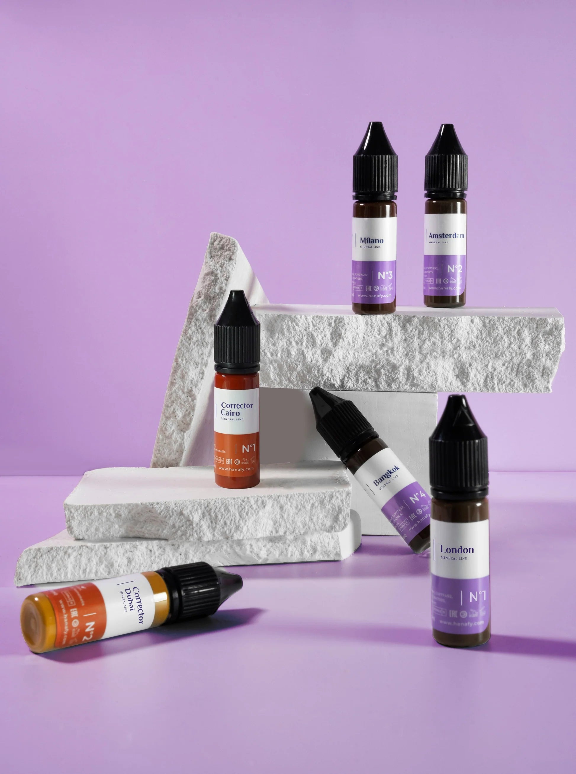 Collection of e-liquid bottles with visible labels on a purple background
