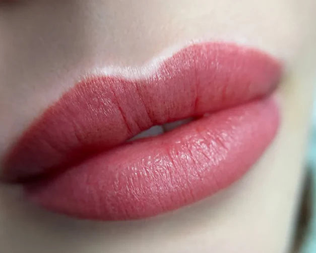 Close-up of a person's lips with pink lipstick