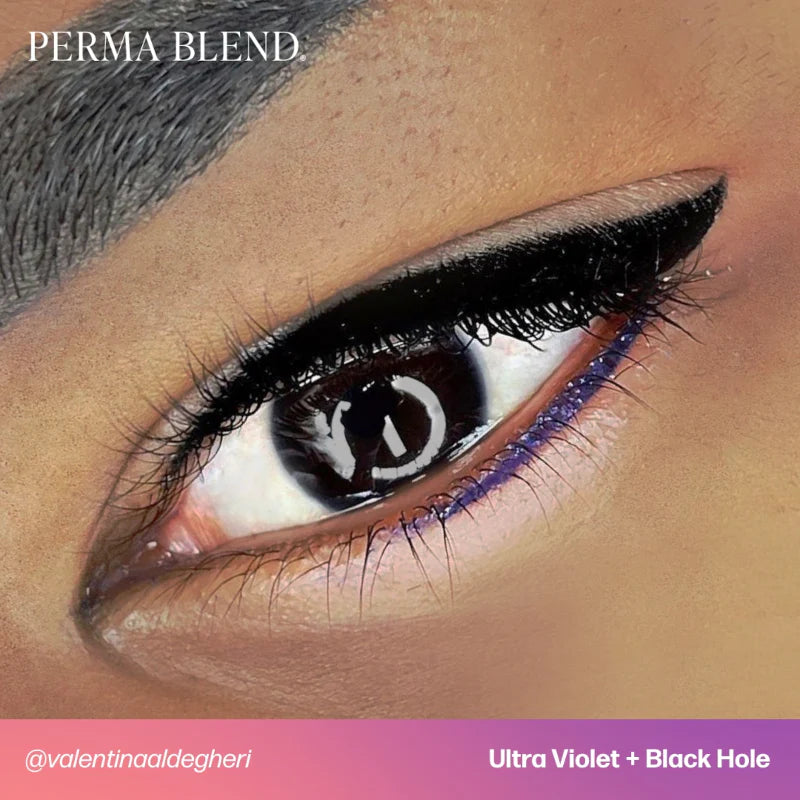 Close-up of an eye with black eyeliner and purple eyeshadow, featuring 'Perma Blend' brand.